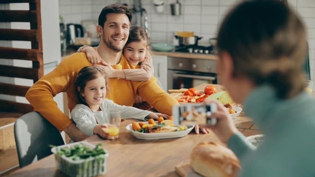 Man smiling while looking over his tidy home and family