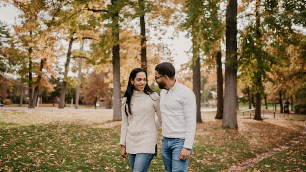 Man sharing his thoughts during a walk with his partner in a park.
