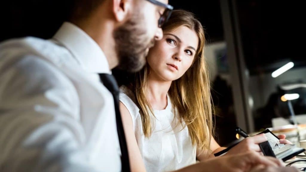 Woman hesitating before speaking at dinner.