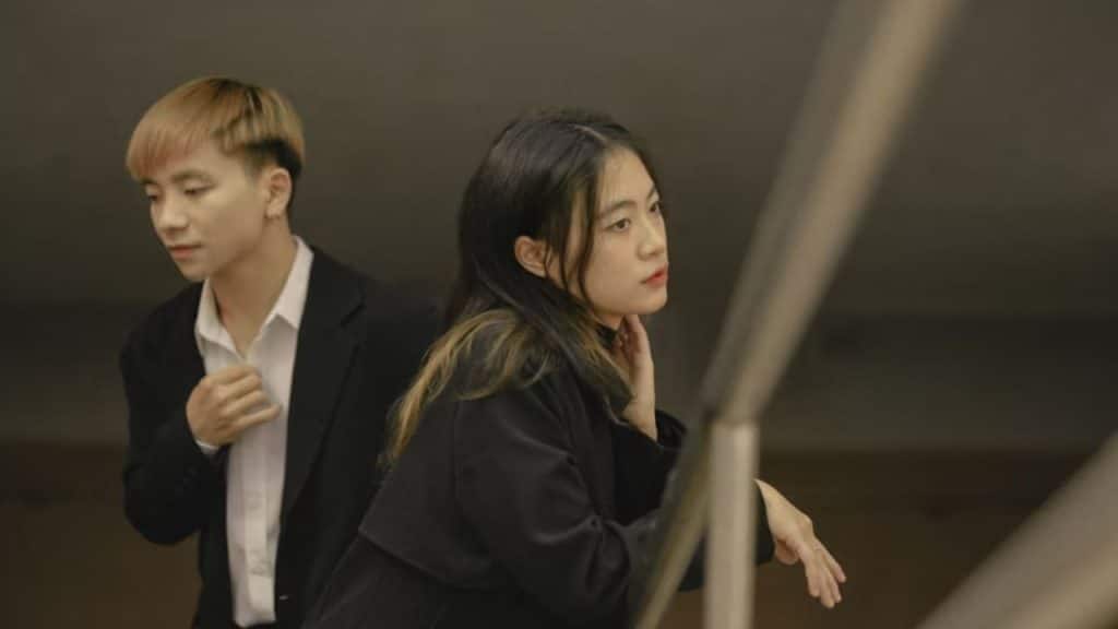 Woman staring blankly while man apologizes.