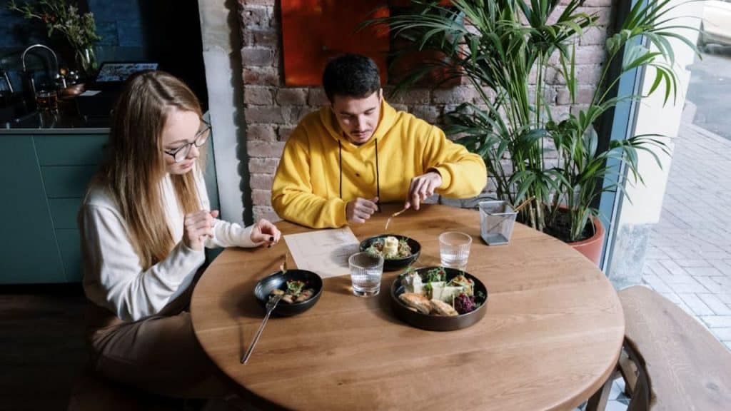 Woman looking tense at dinner table.