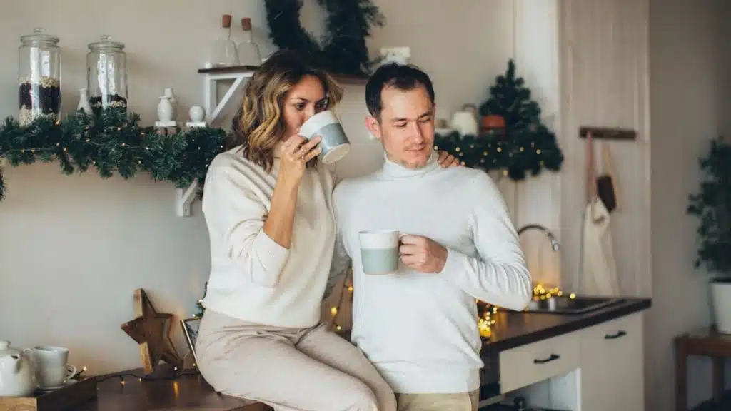 A man bringing coffee to his partner during a quiet morning.