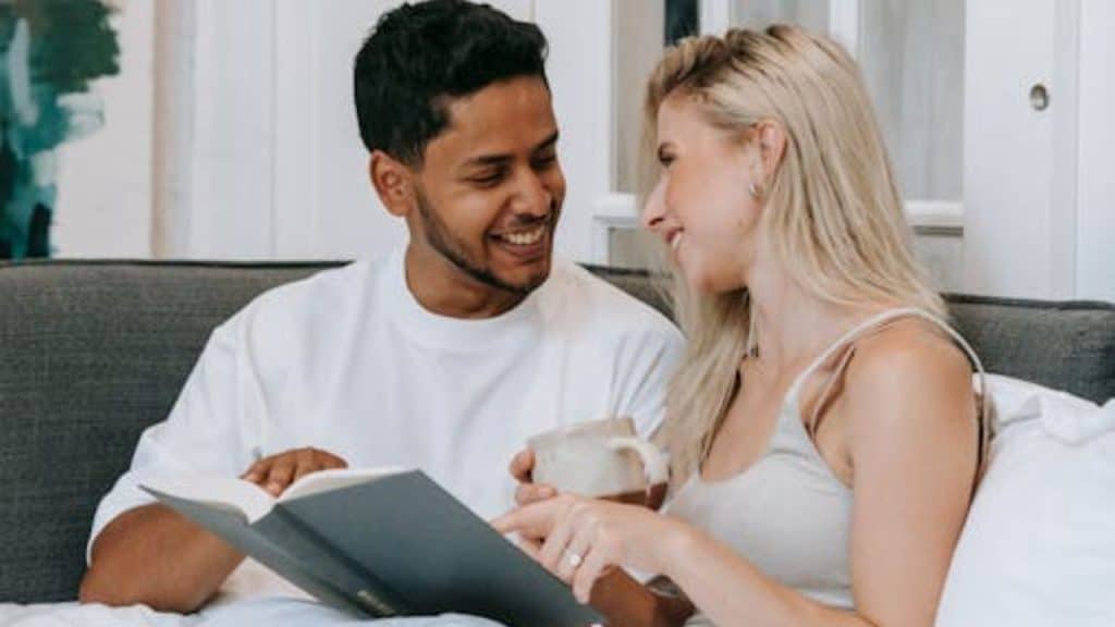 Woman smiling at partner over coffee.