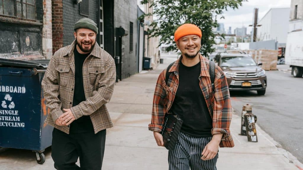 A pair of men walking and laughing outside.
