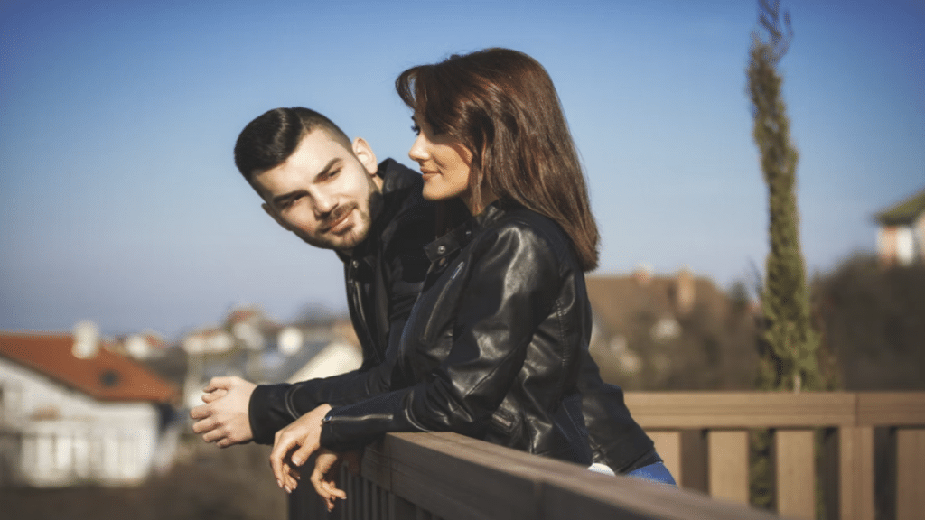 A man looking at a woman while smiling.