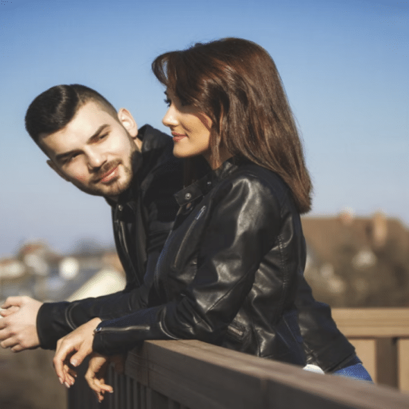 A man looking at a woman while smiling.