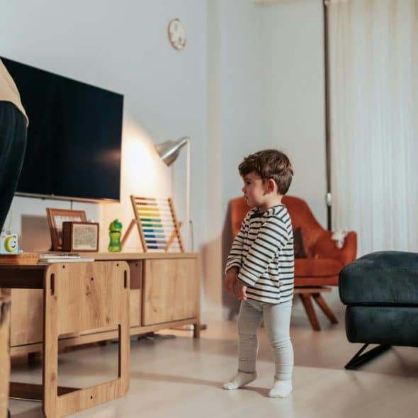 A toddler standing in a living room.