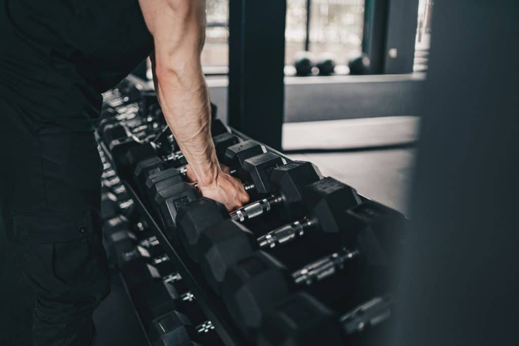 A man taking a barbell
