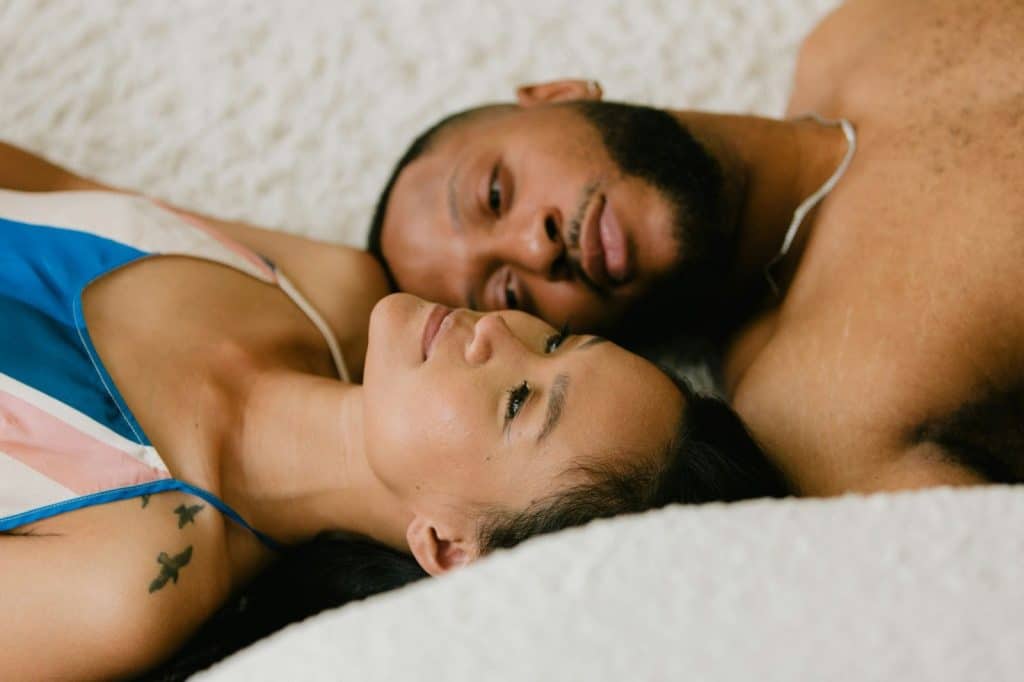 A man and woman laying on the floor 