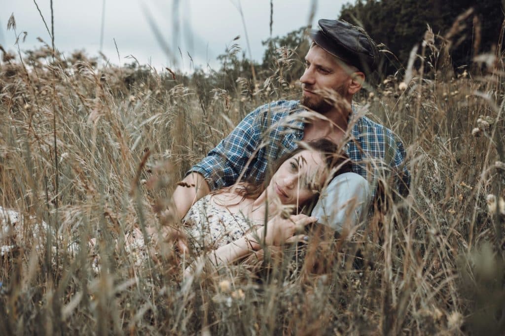 A man and woman at the grass field