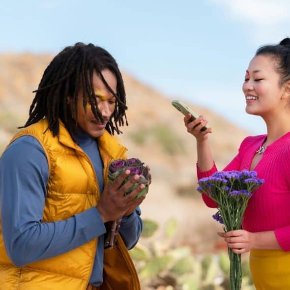 A couple taking a picture of the flowers