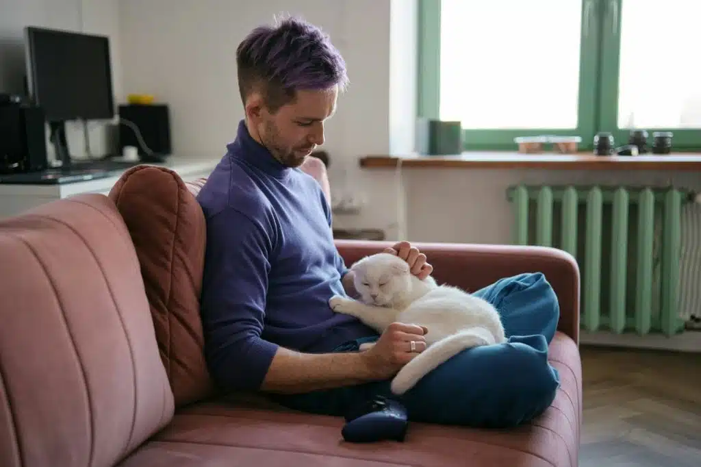 A man at home with his cat 