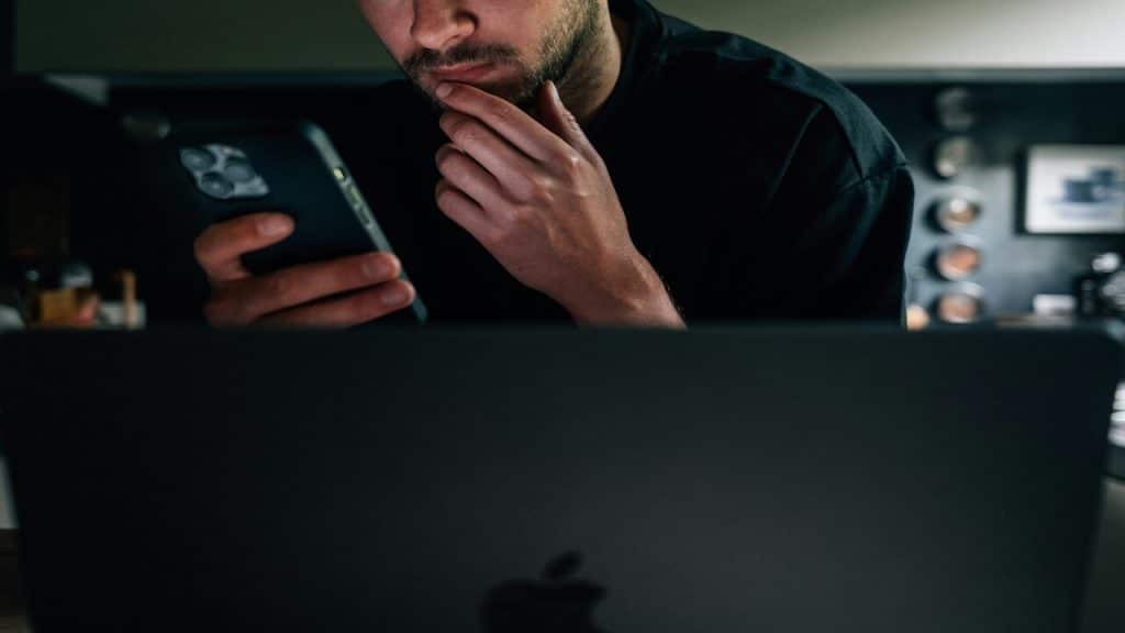 A man quietly texting at home.