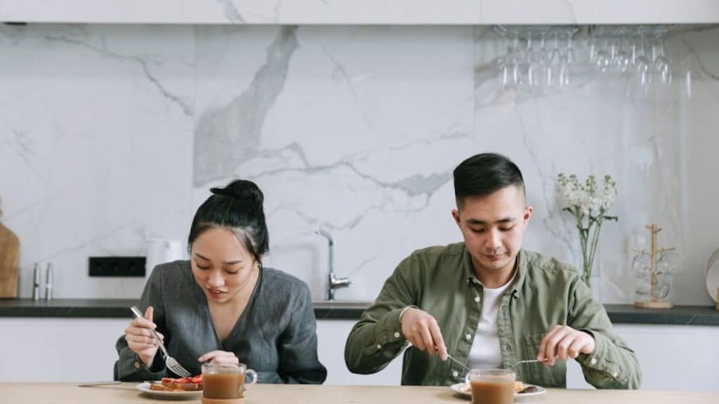 Couple at dinner avoiding eye contact while eating