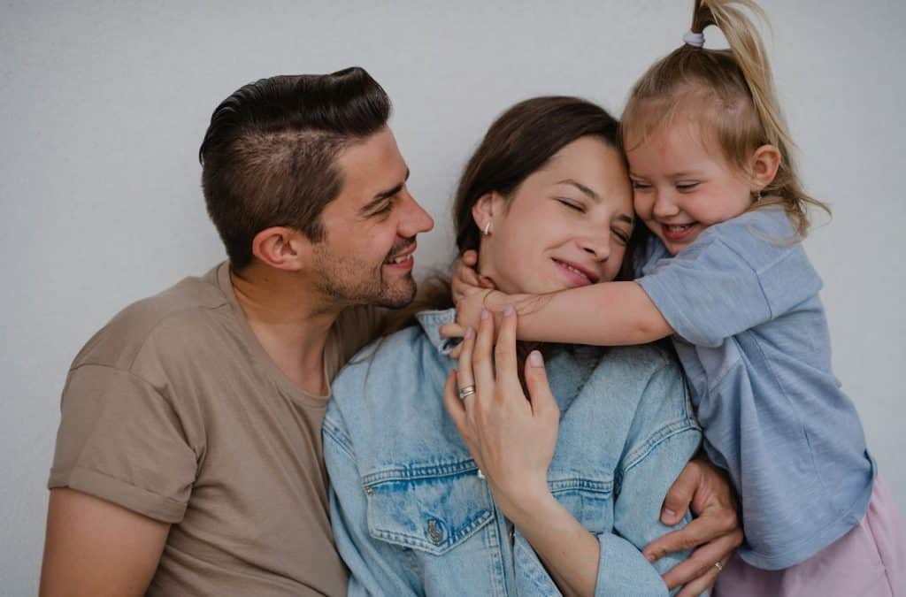 A man looking at his wife and his daughter