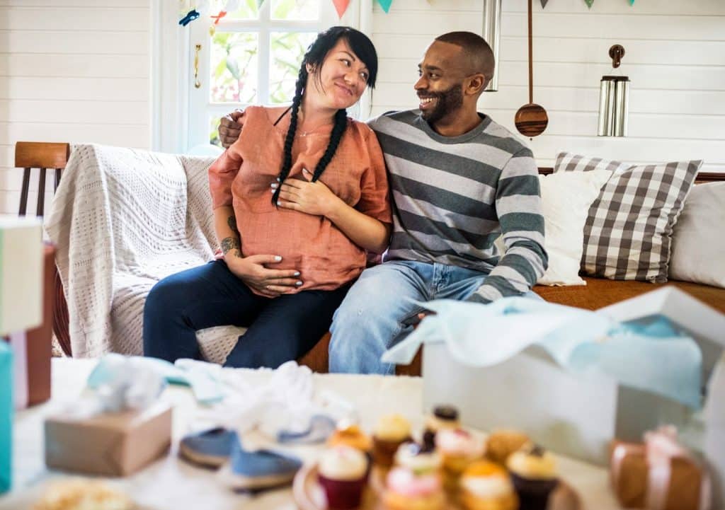 A man and woman sitting at the couch
