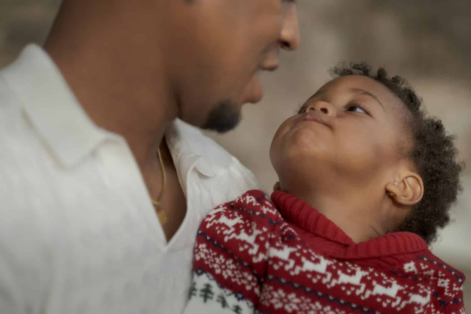 A man carrying a child.
