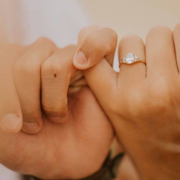 A couple doing a pinky promise.