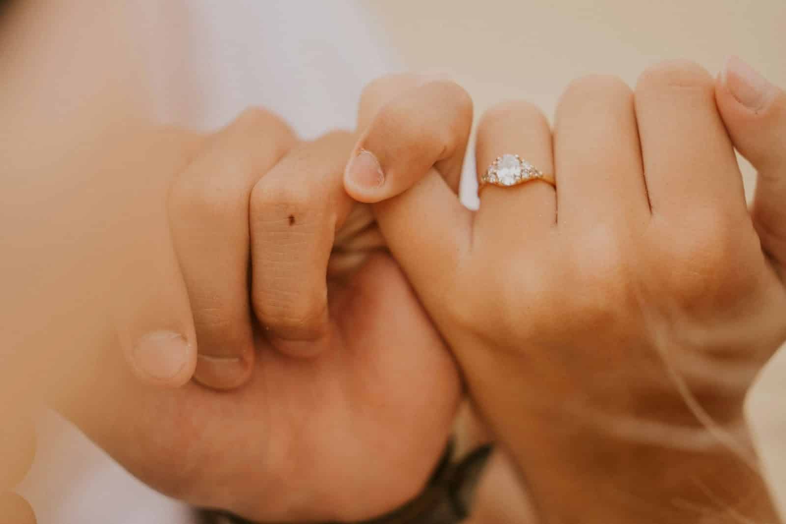 A couple doing a pinky promise.