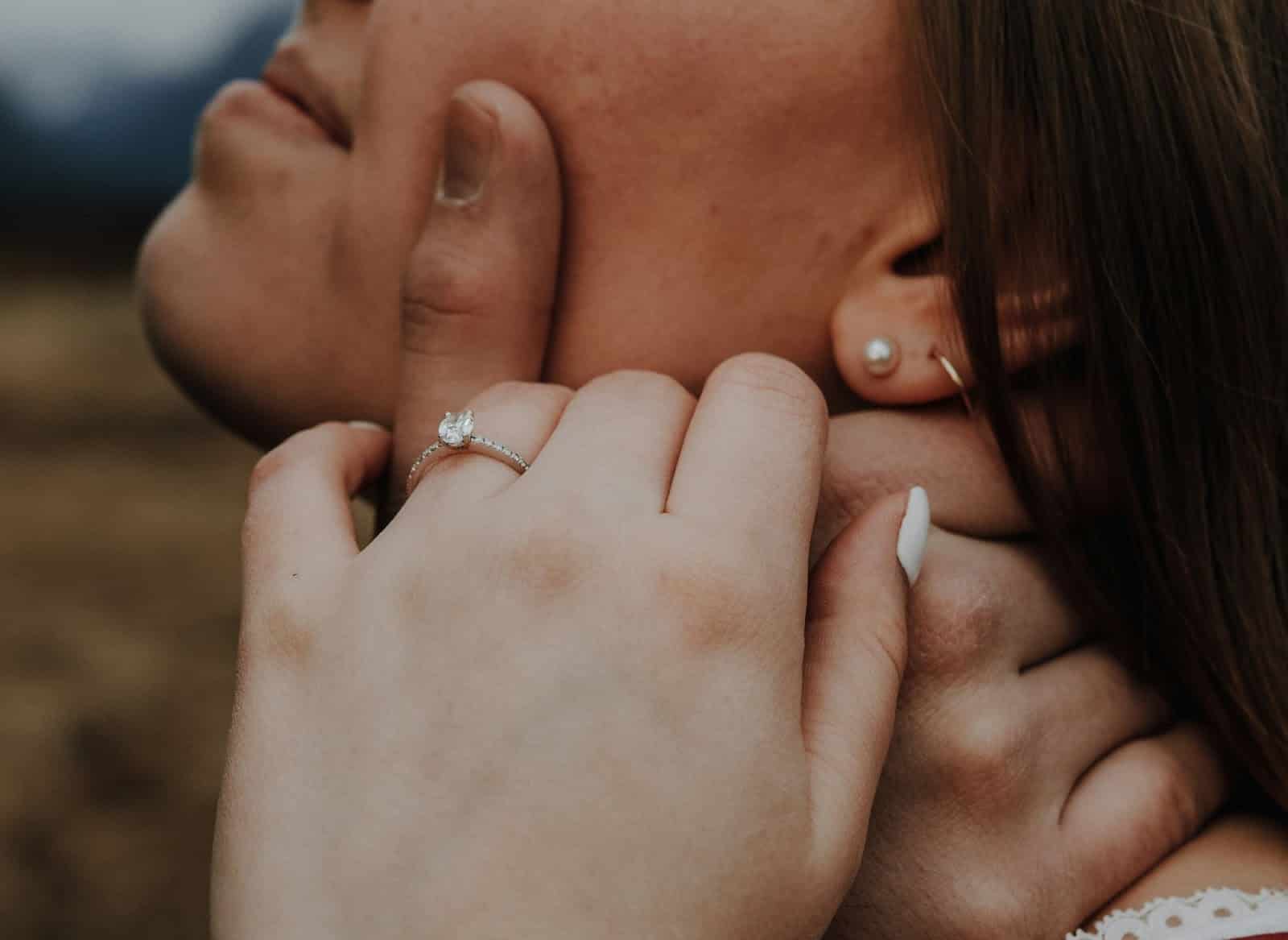 A man holding a woman’s face.