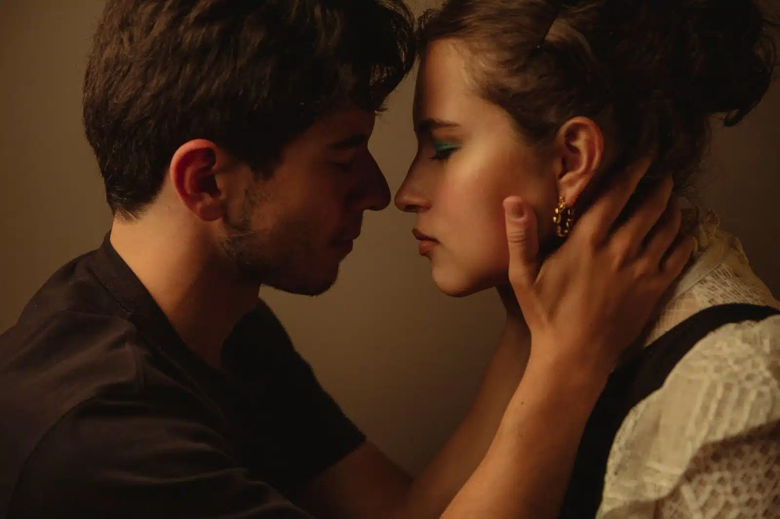 A man holding a woman’s face.