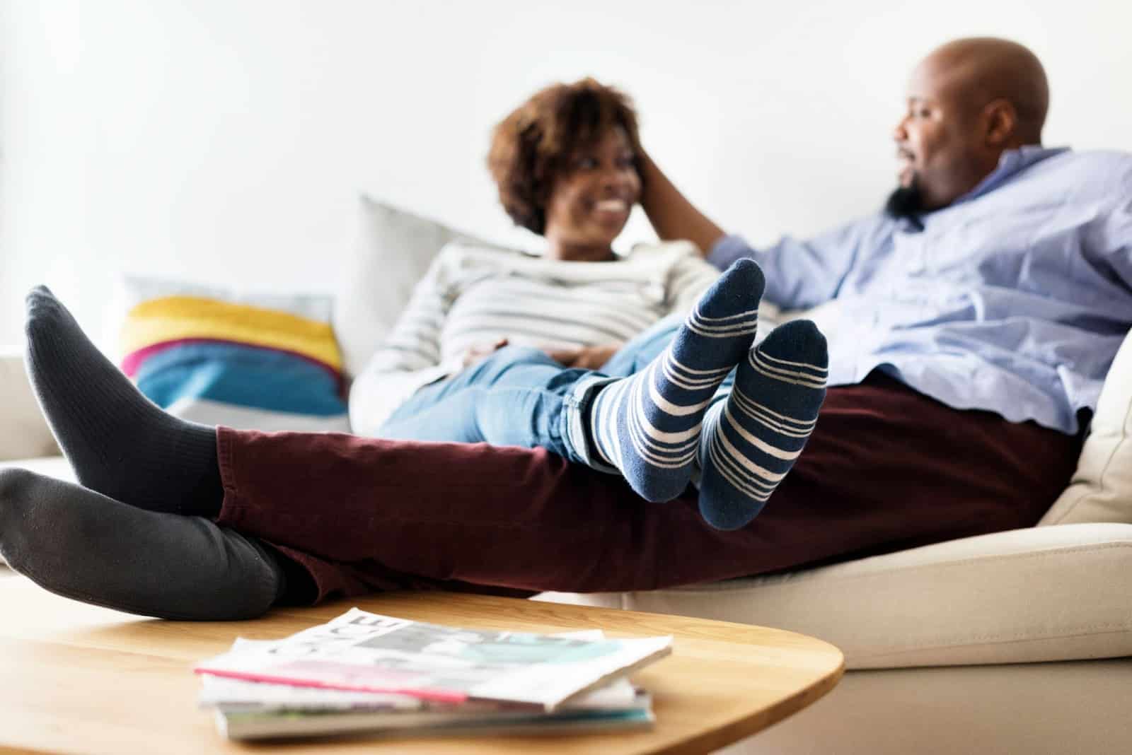 A man and woman relaxing at home.