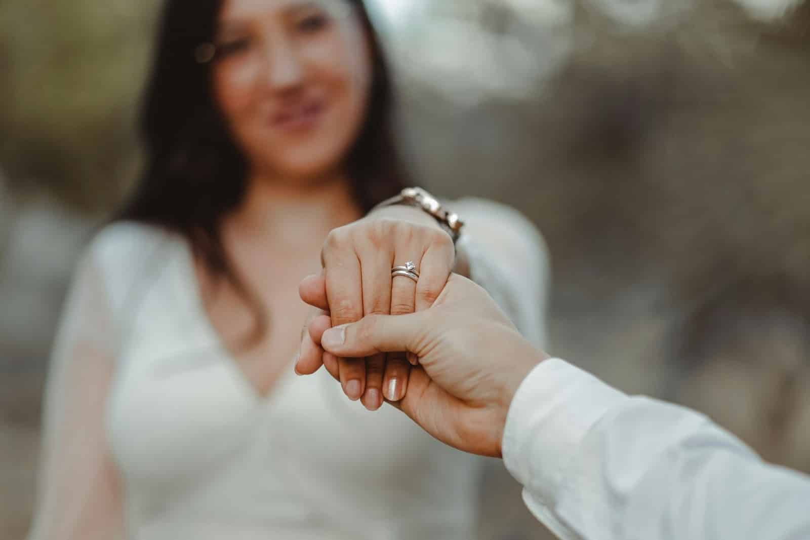 A man holding a woman’s hand.