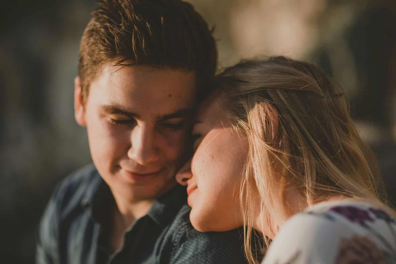 A woman resting her head to a man’s shoulder.