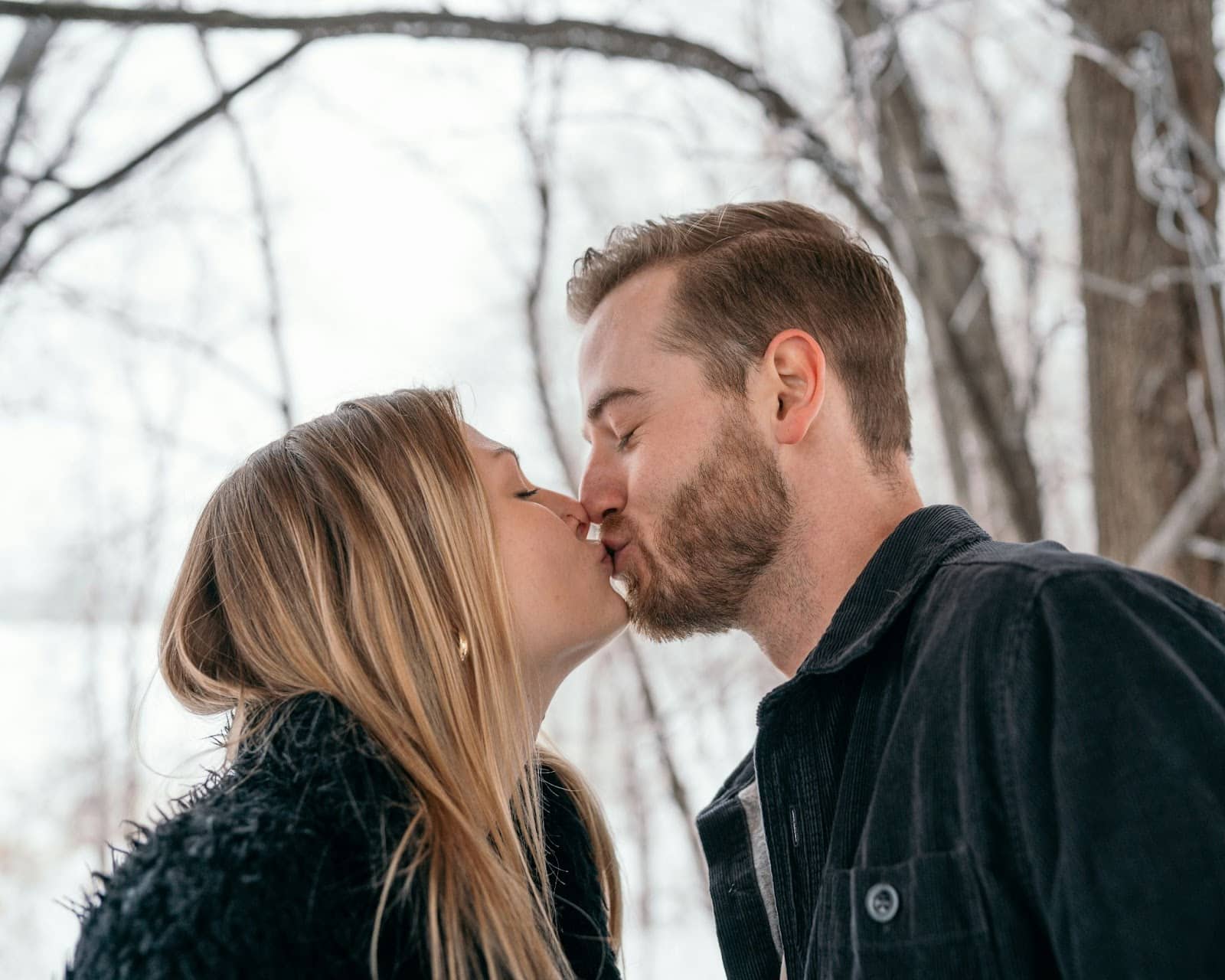 A man and woman kissing.