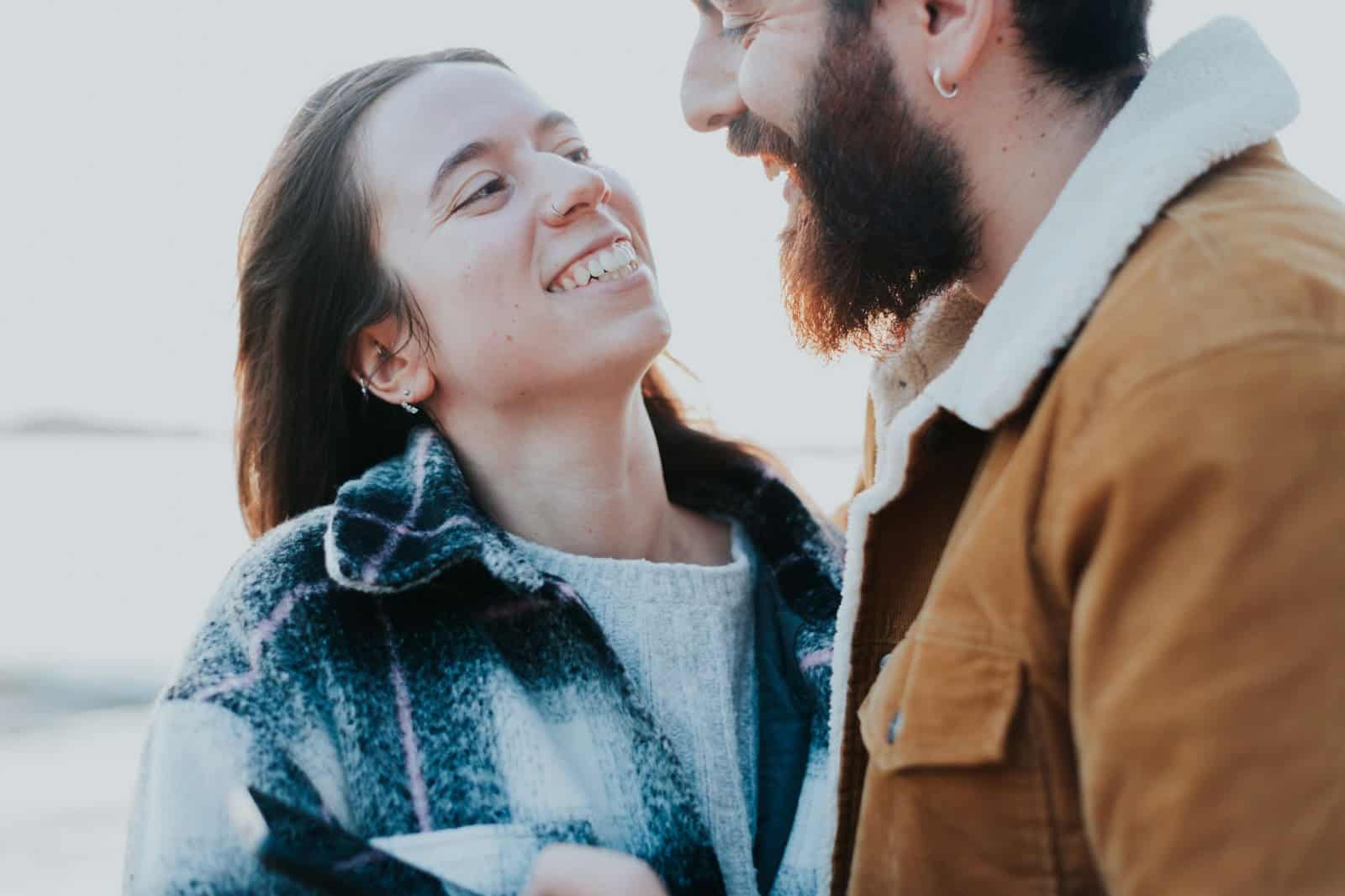 A man and woman smiling at each other.
