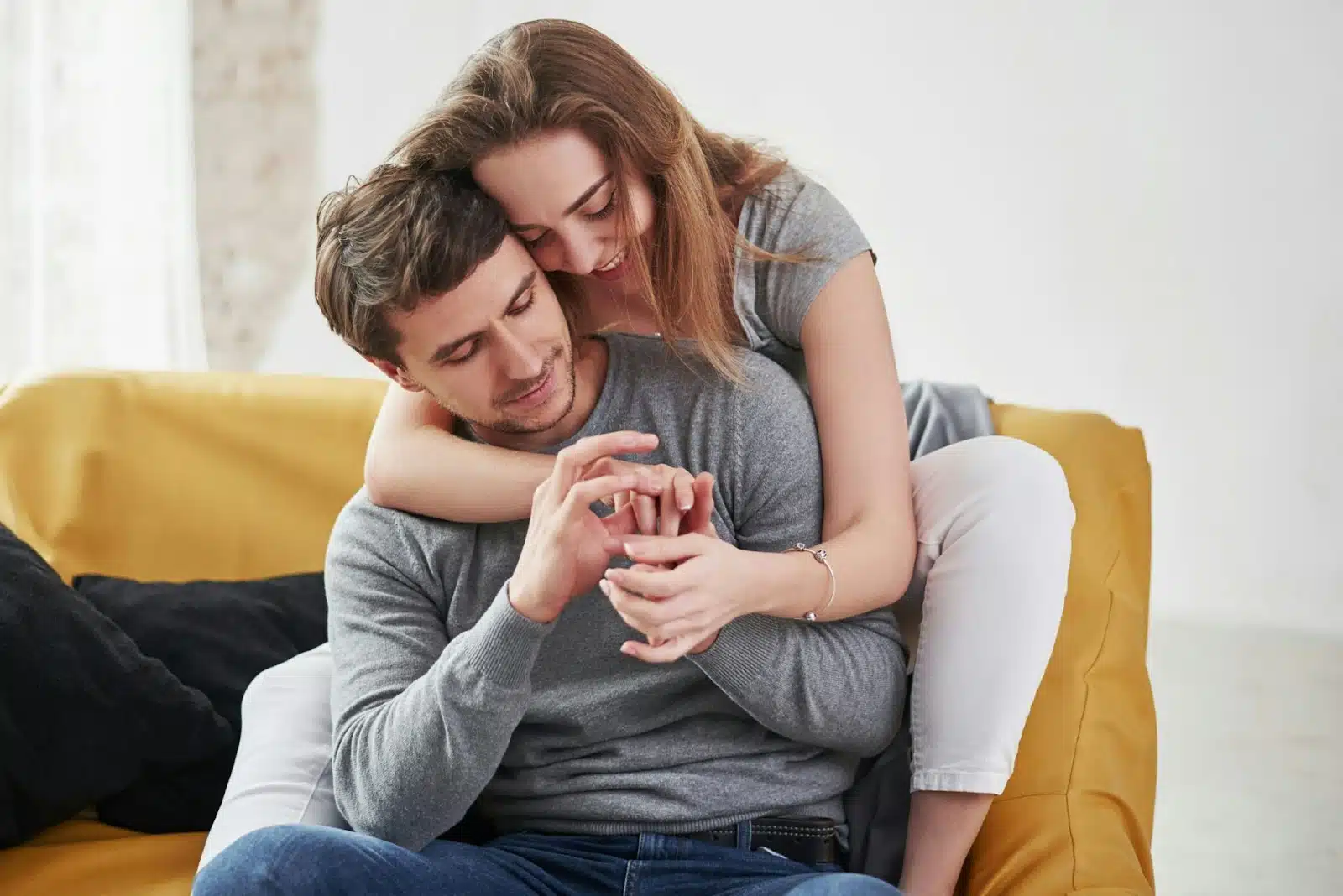 A man getting back hug from a woman.