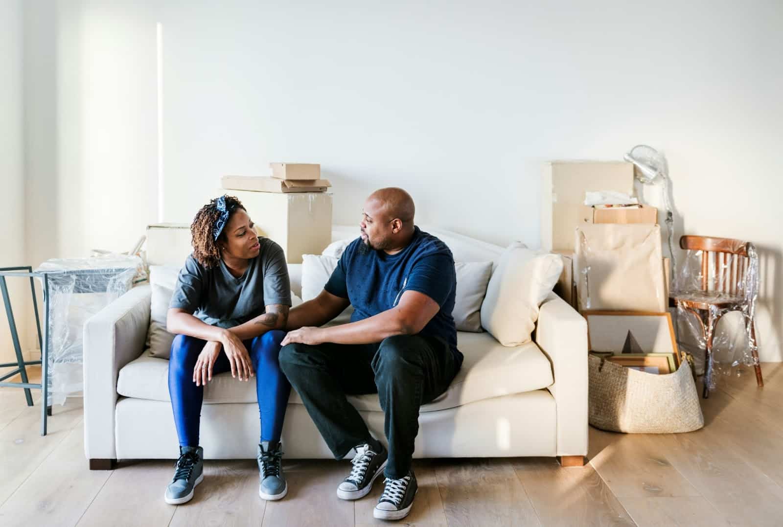 A man and woman sitting at the couch.