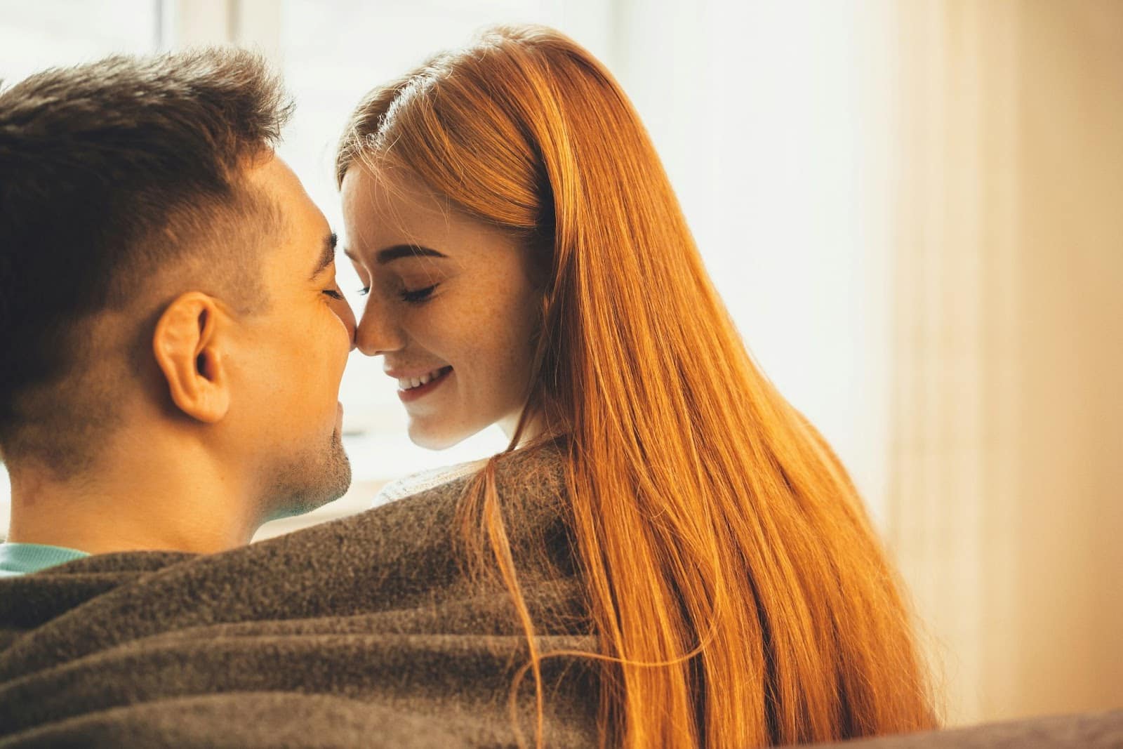 A man and woman being close together.