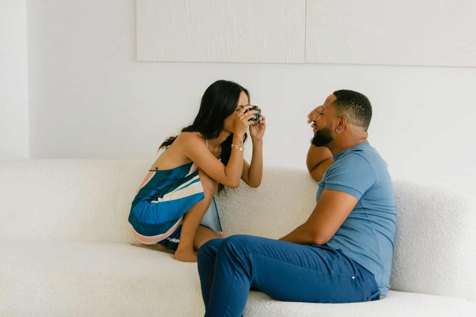 A woman taking a picture of a man.