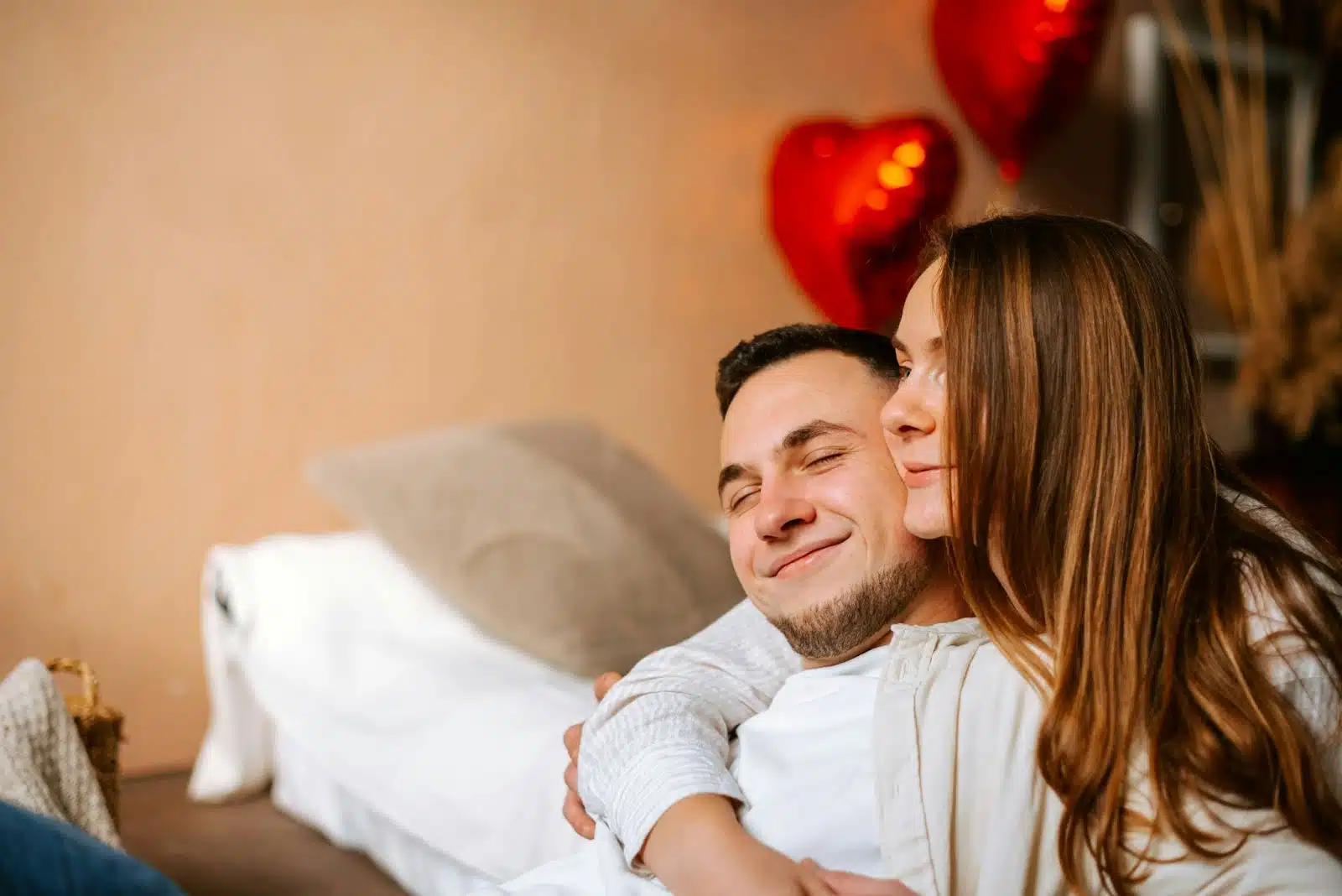 A man cuddling a woman.