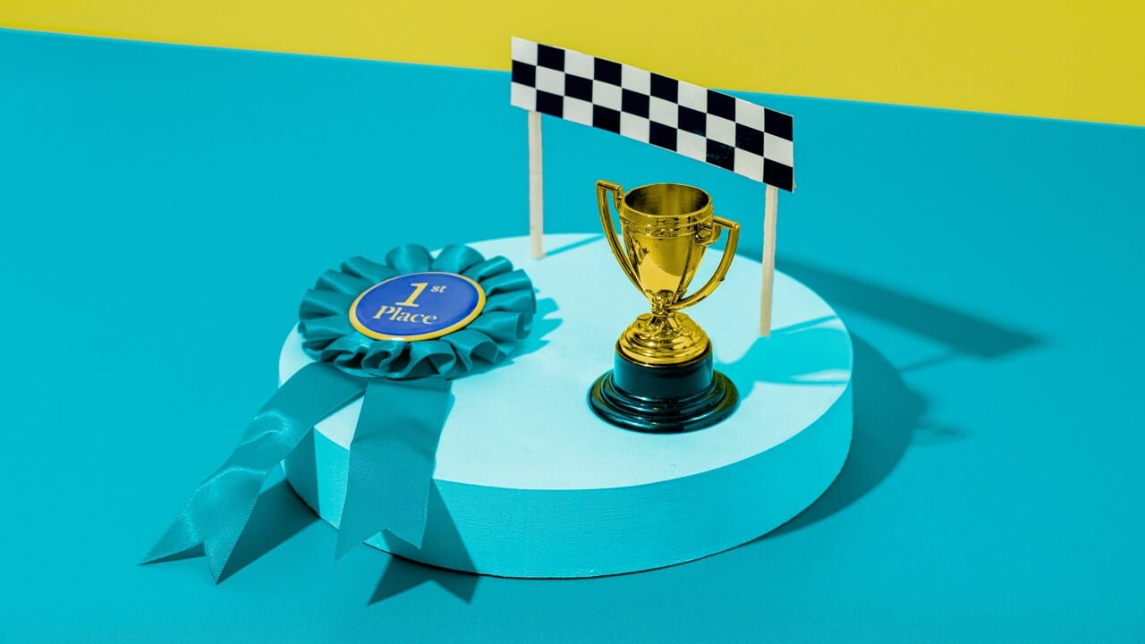 A trophy and a first place ribbon.