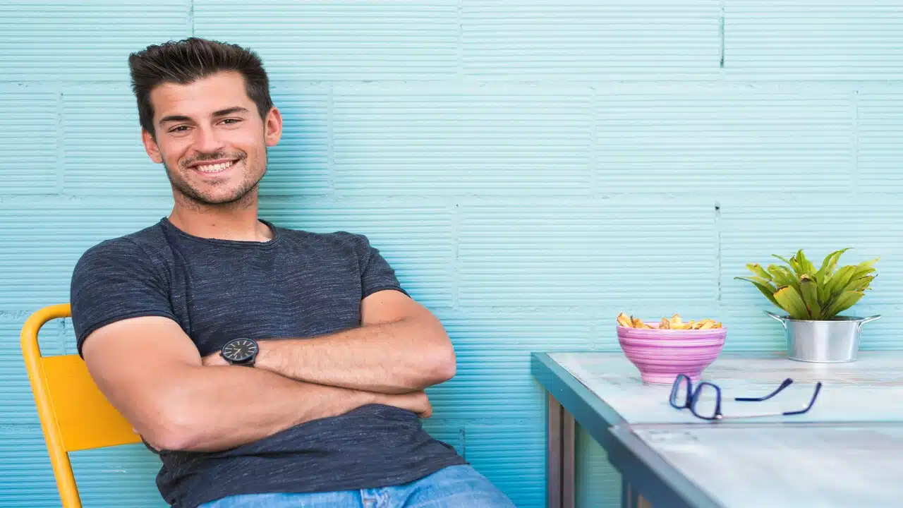 A man smiling at a restaurant.