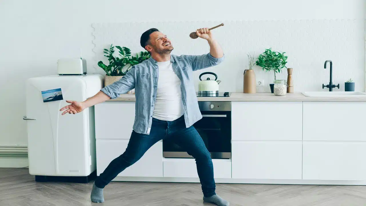 A man goofing off in the kitchen.