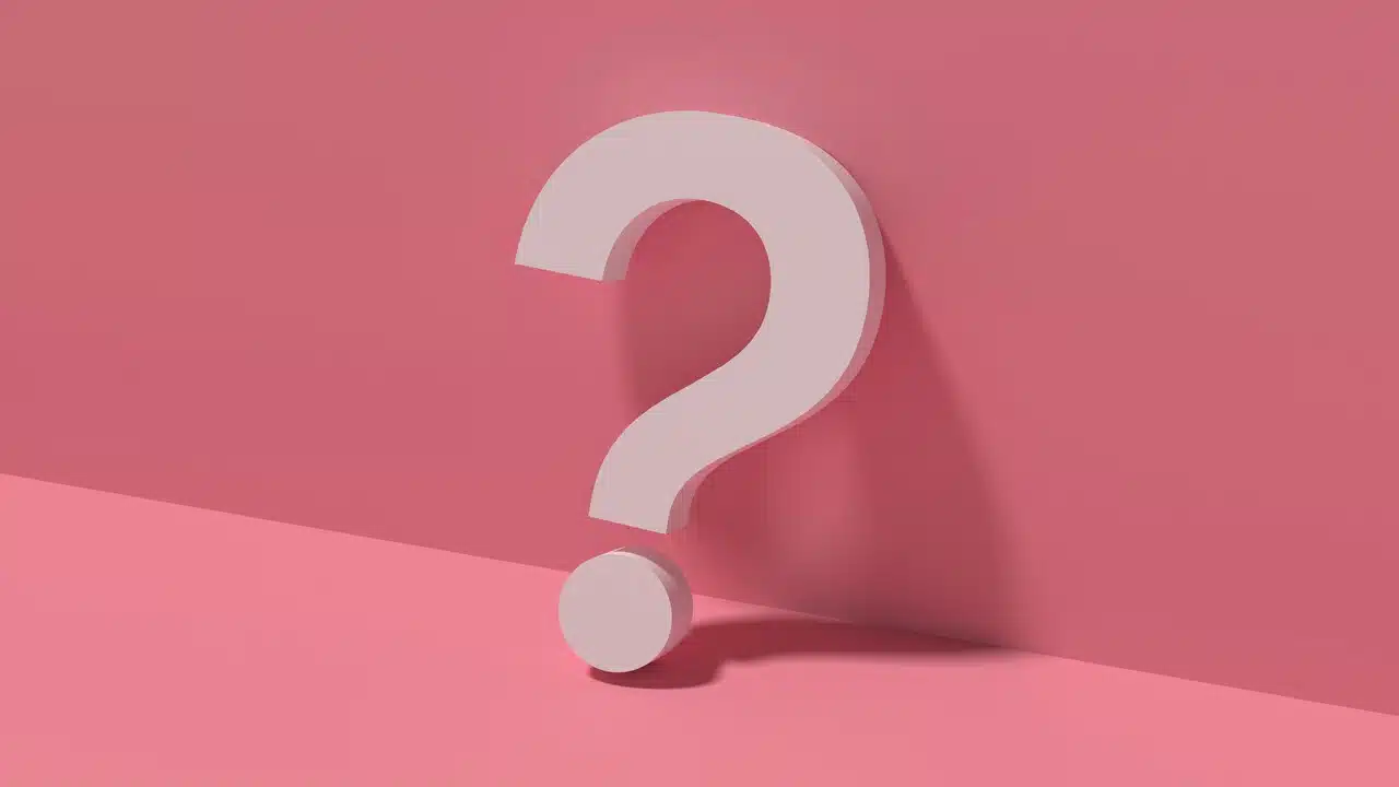 A question mark on a pink background.