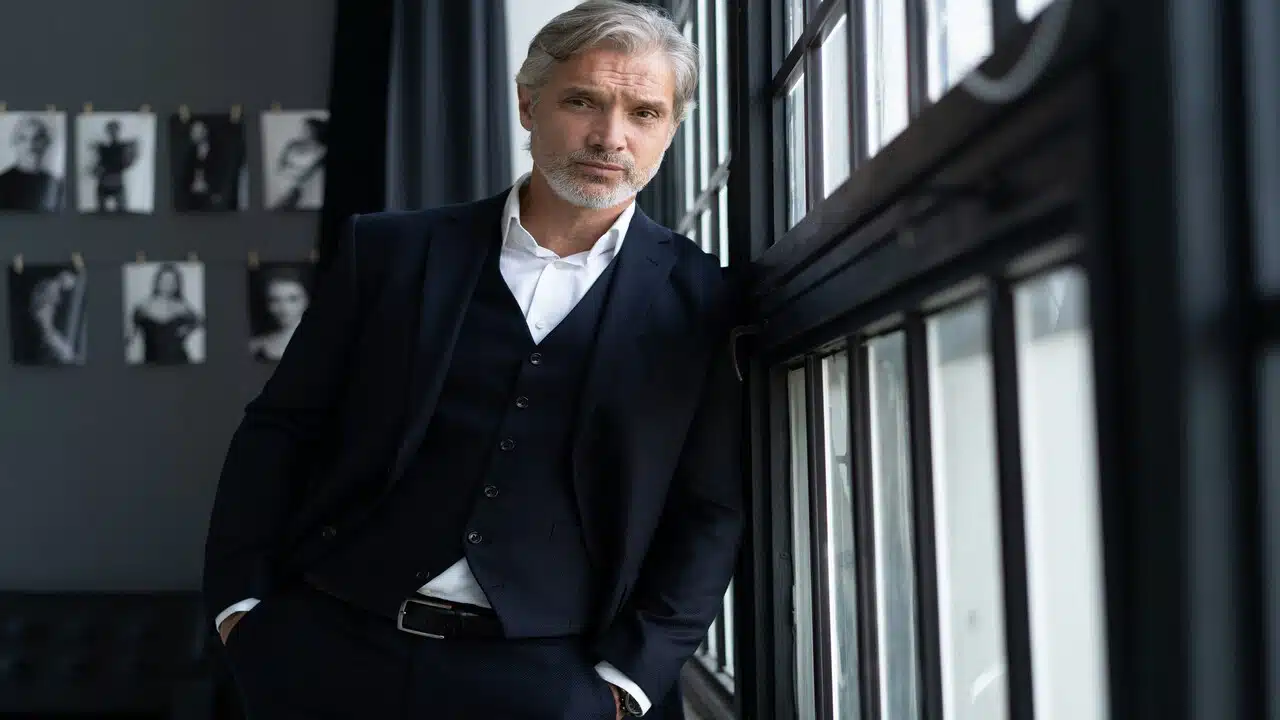 A handsome man near the window.