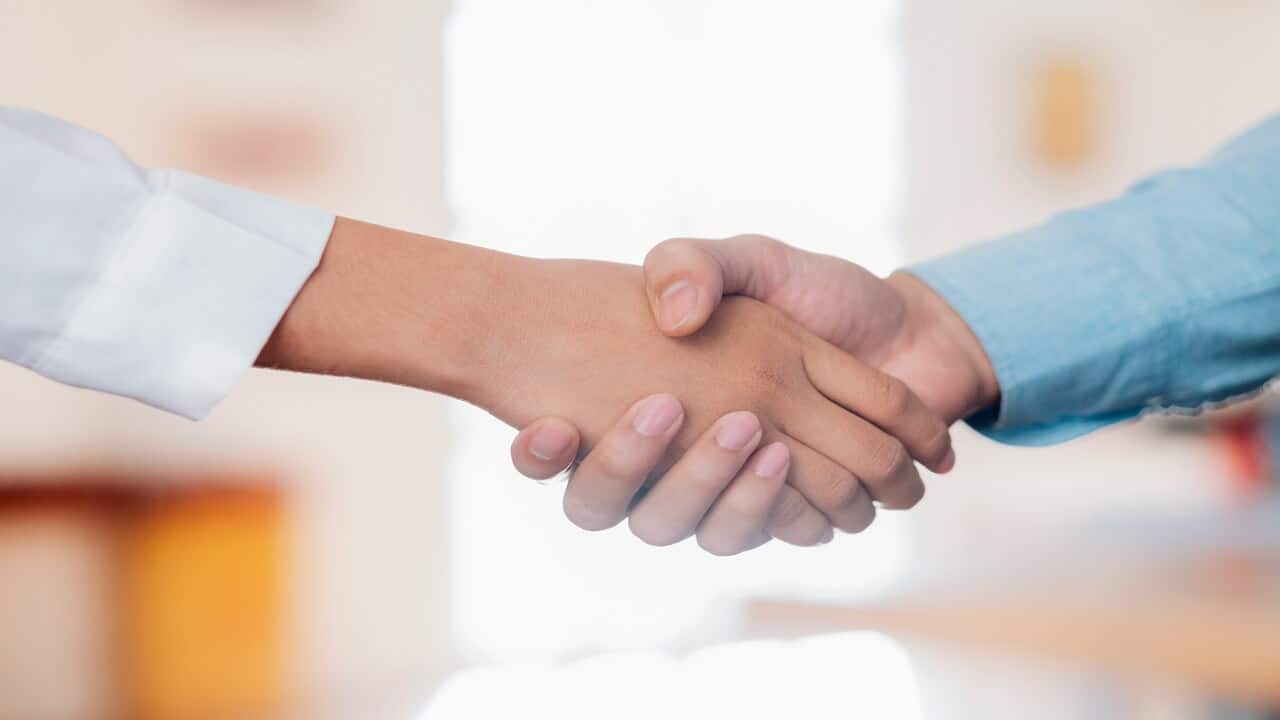 Two people shaking hands.
