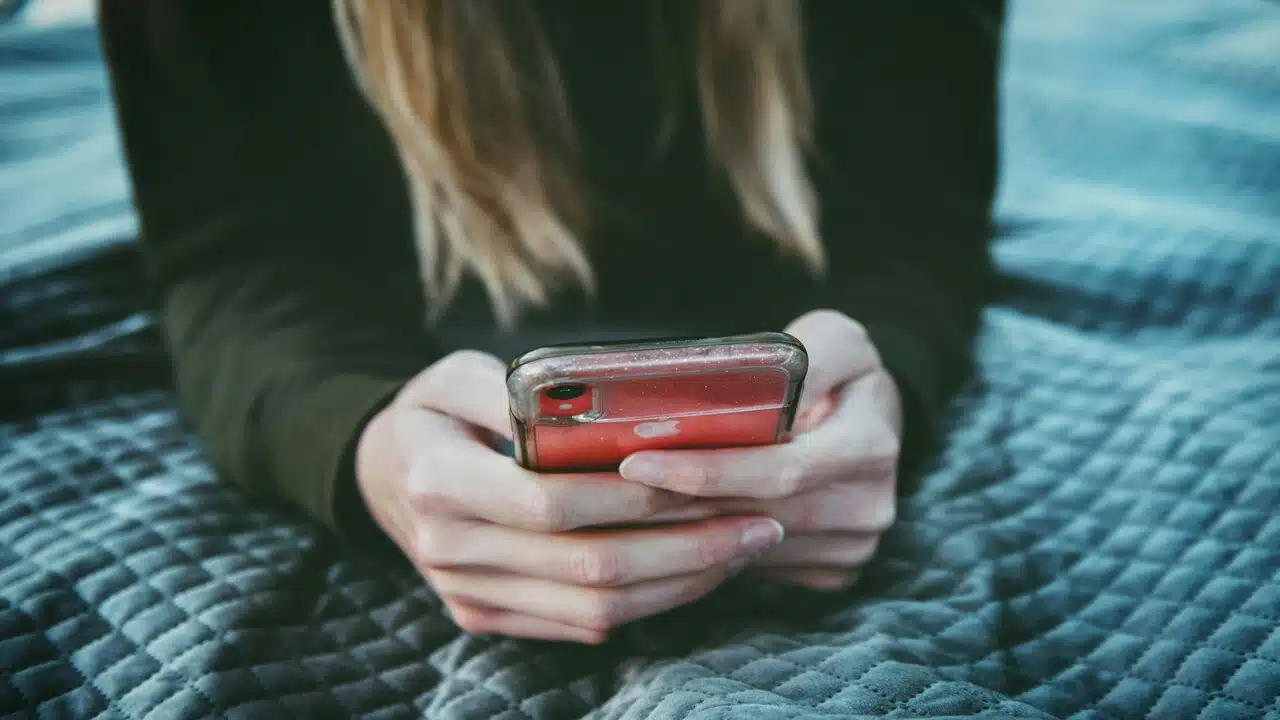 A woman waiting for a text.