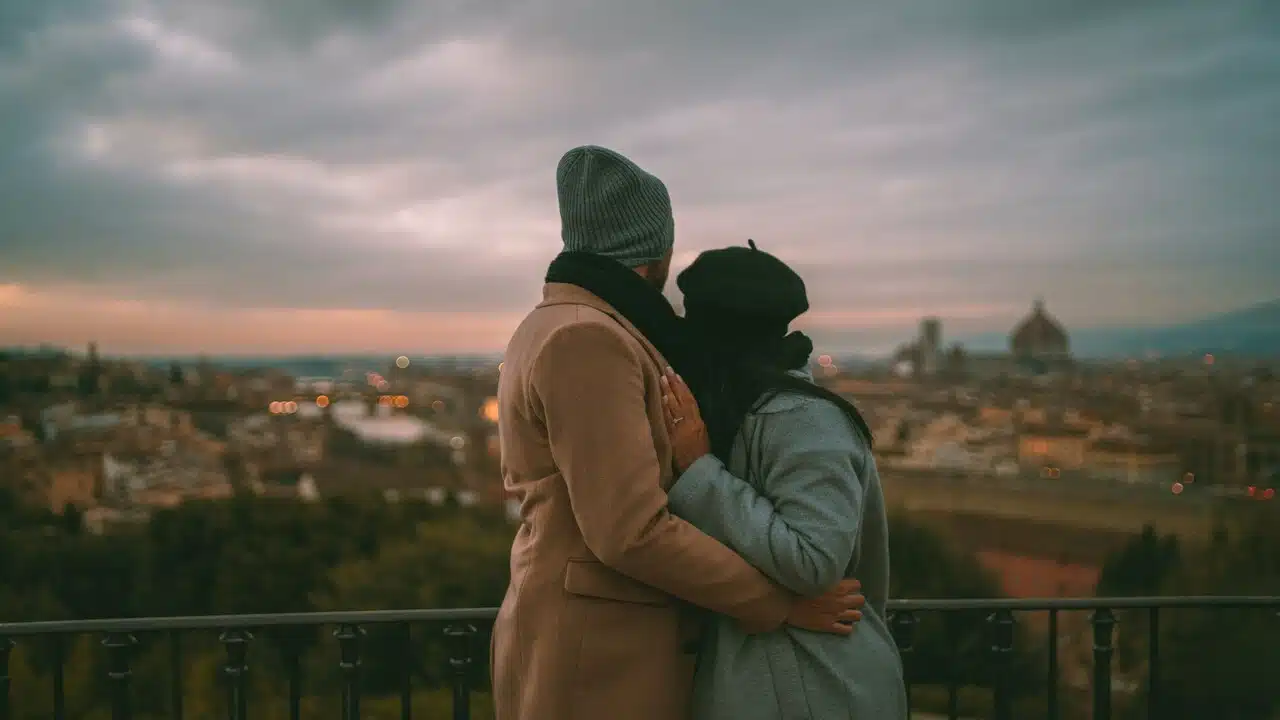 A couple hugging at a rooftop.