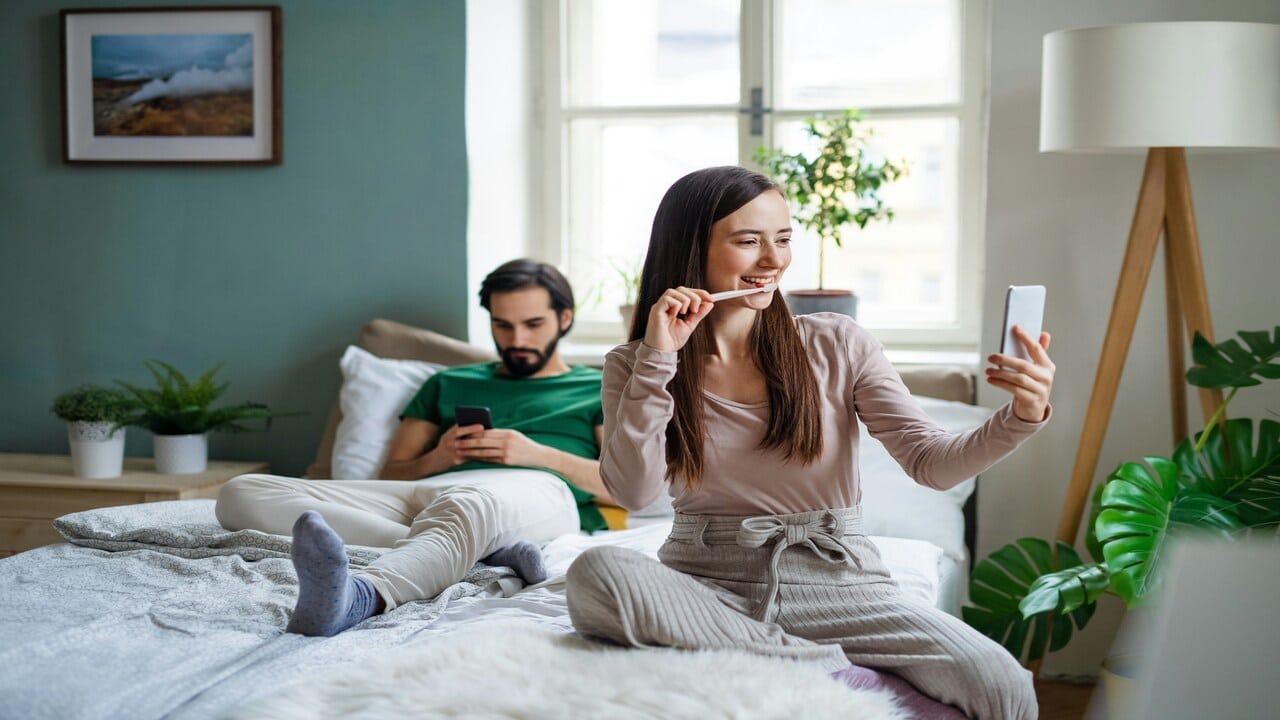 A couple ignoring each other at home.
