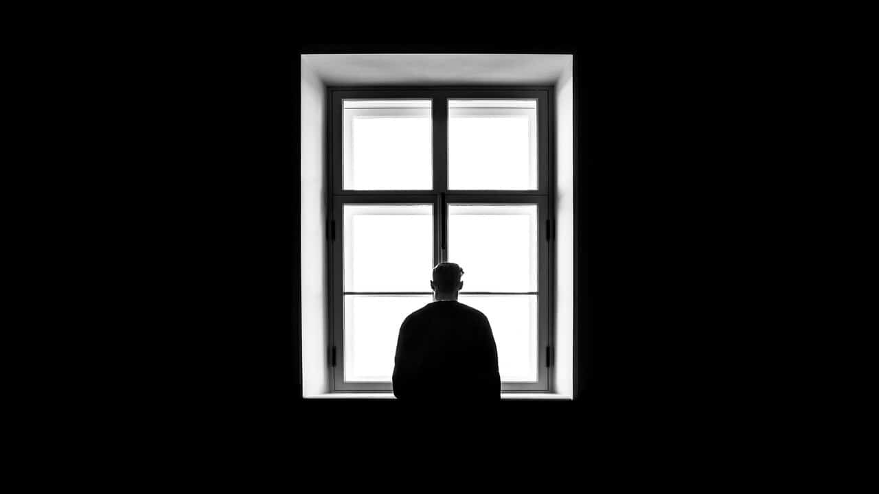 A sad man looking out the window.