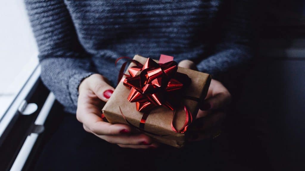 A woman handing a gift.