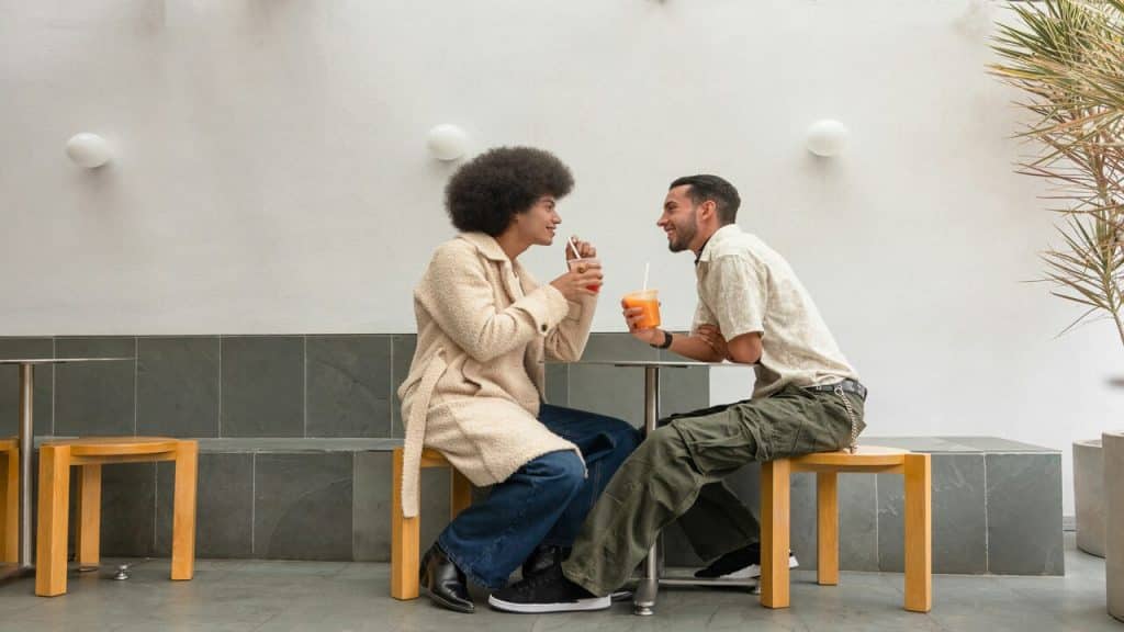 A couple talking at a cafe.