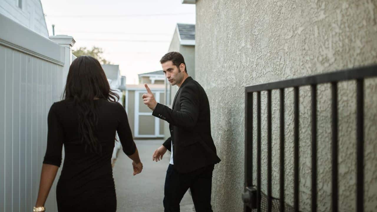 Man prioritizing being right during argument while partner looks frustrated.