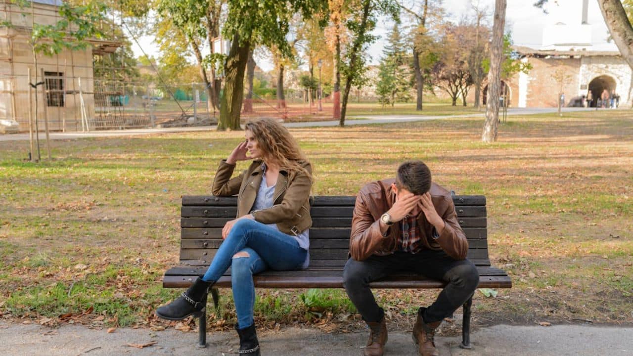 Man dismissing his partner’s emotional needs during conversation.
