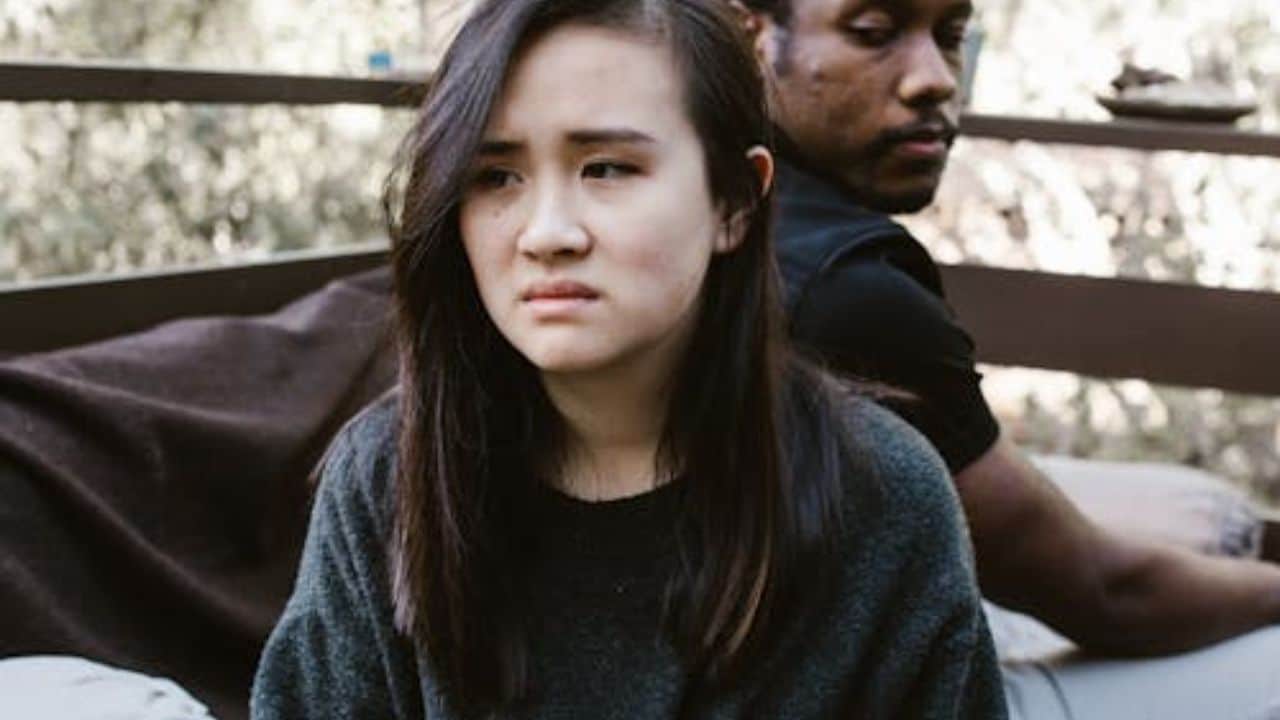 Couple sitting in awkward silence after an unresolved issue.